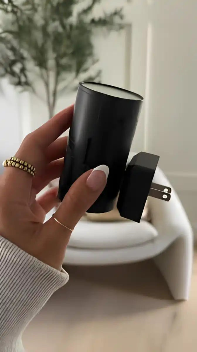 black-cylindrical-air-freshener-two-pronged-electrical-plug.webp