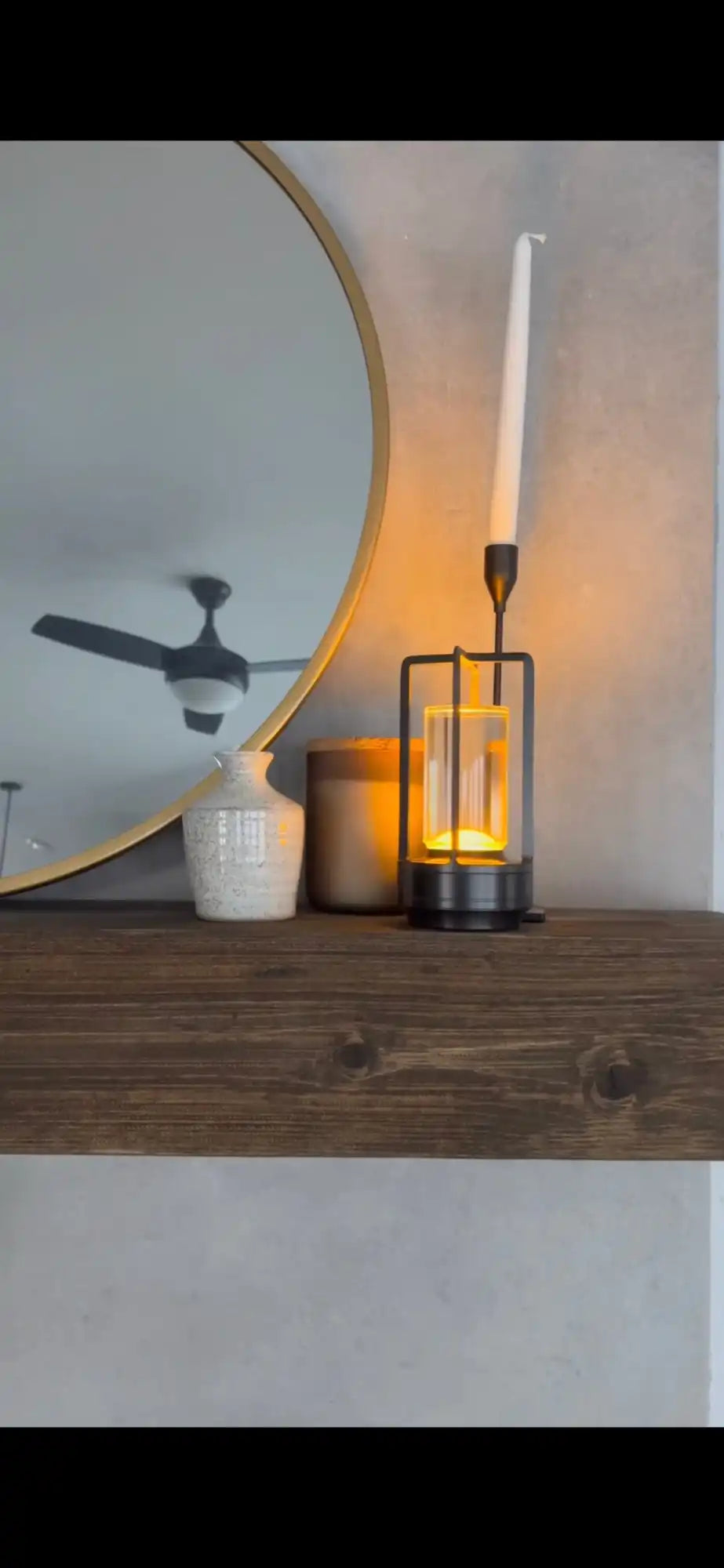 black-metal-candle-holder-clear-glass-cylinder-white-taper.webp