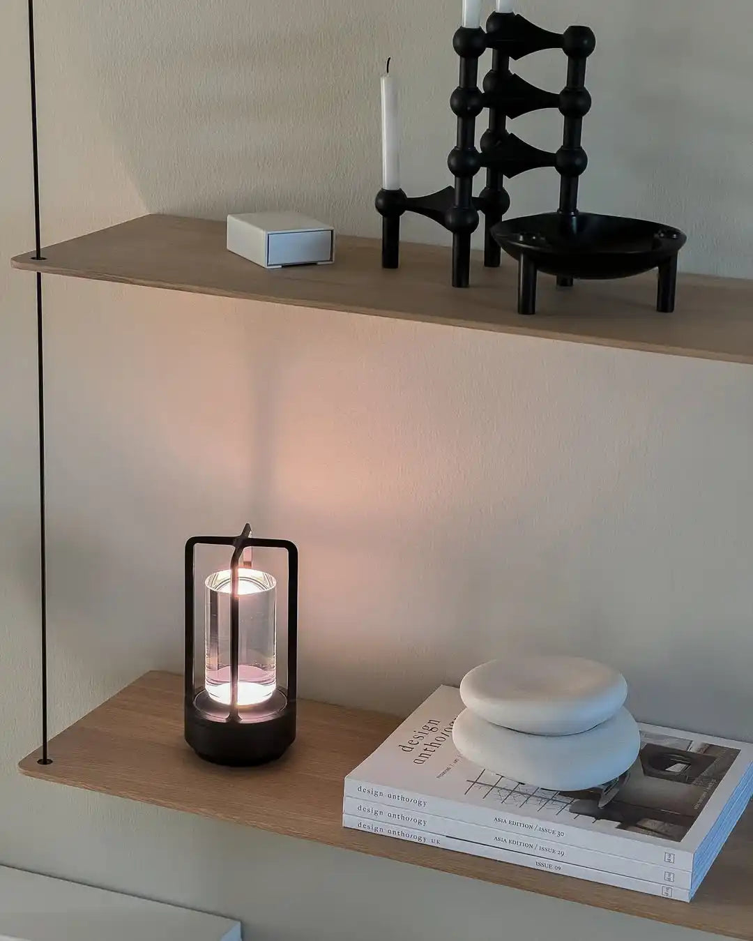 black-modular-candle-holder-white-candles-bowl-shaped-three-legs.webp