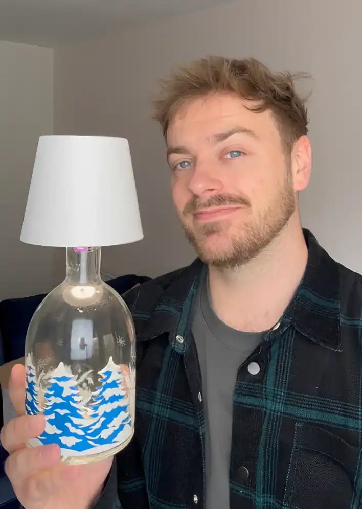 clear-glass-bottle-converted-lamp-white-lampshade-blue-winter-landscape-design.webp