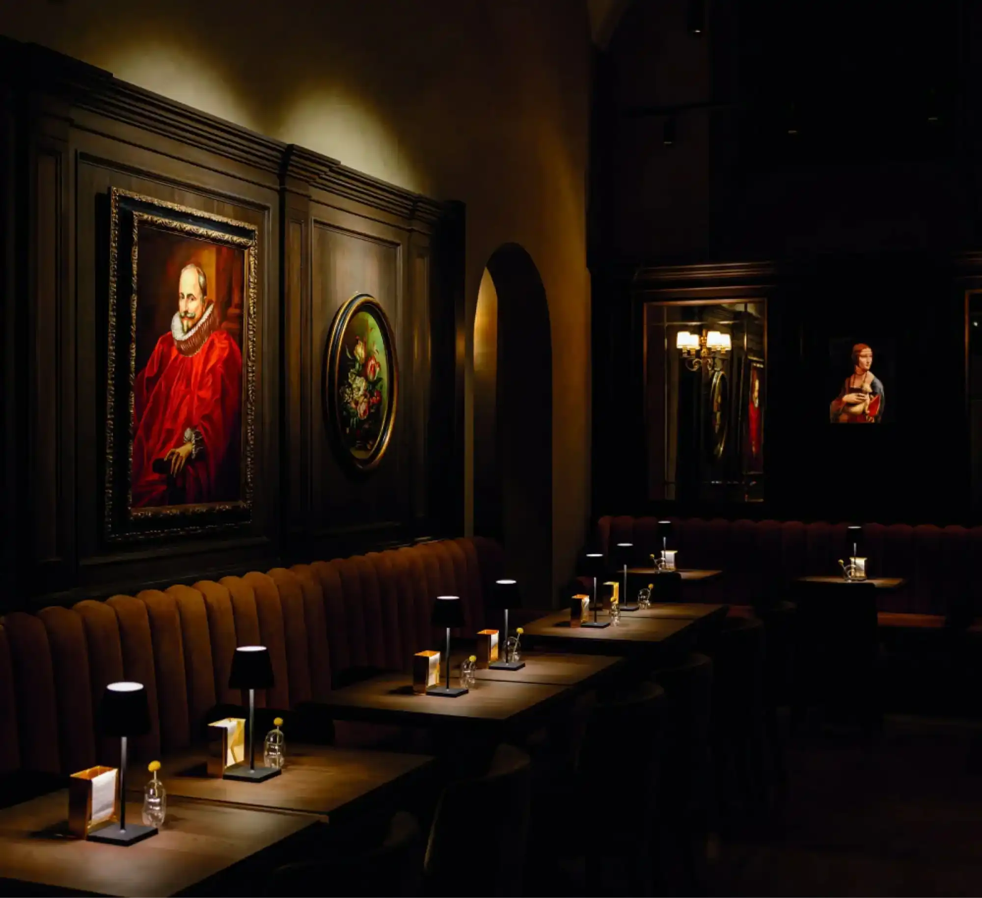 dark-richly-decorated-restaurant-bar-booth-seating-individual-table-lamps.webp