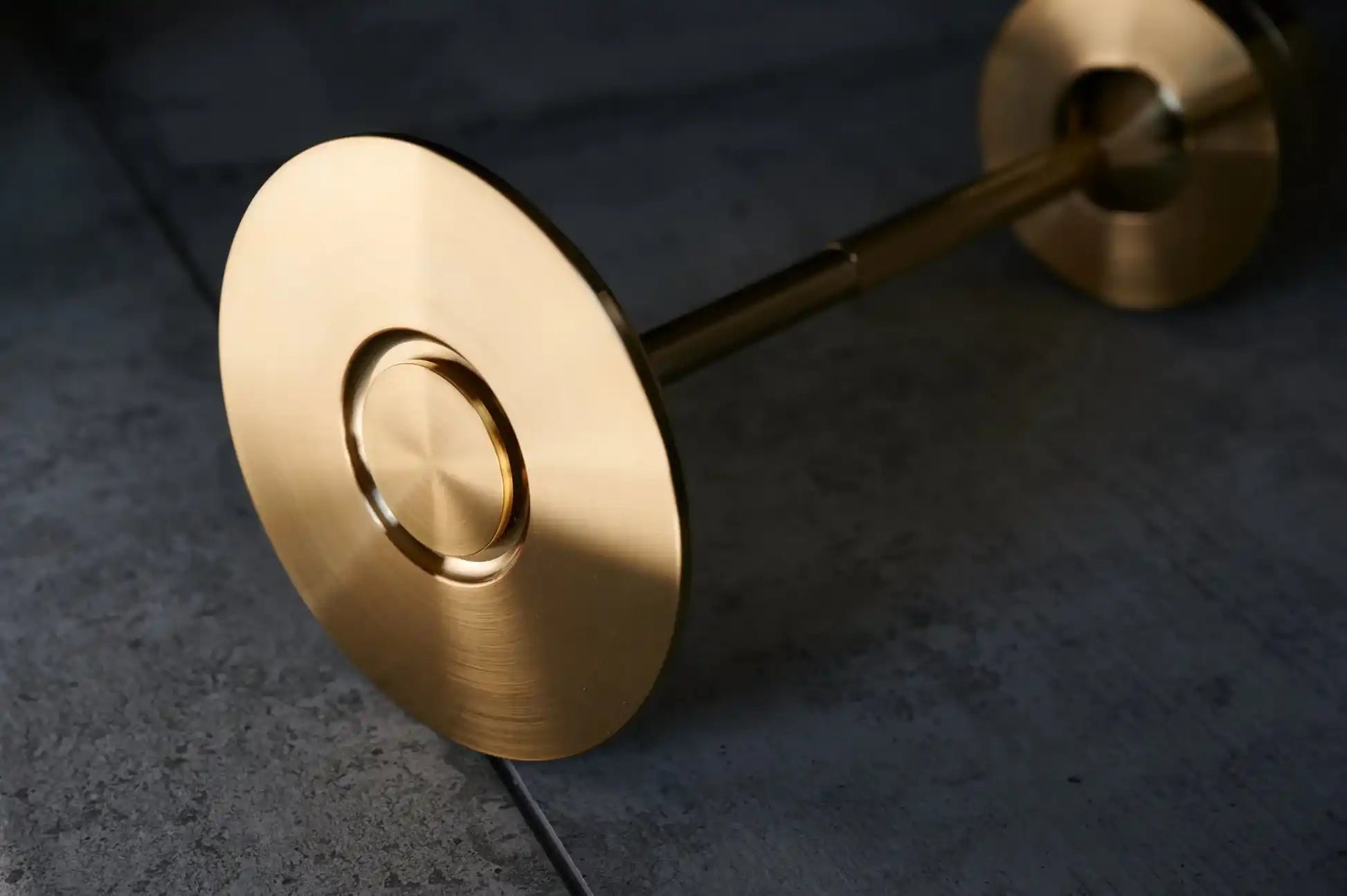 sleek-golden-barbell-polished-circular-weight-plates.webp
